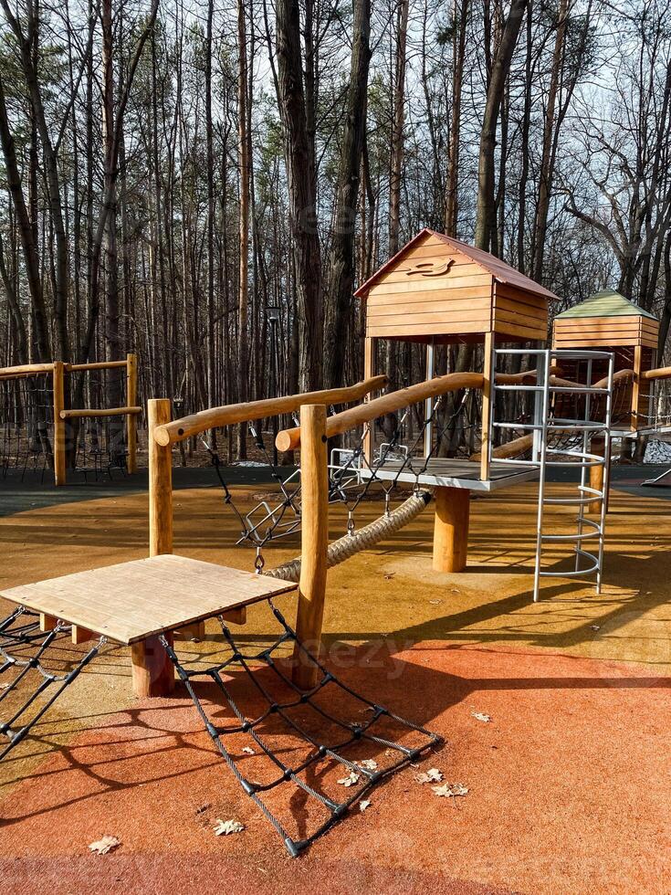 An inviting playground designed specifically for children, beautifully surrounded by nature, featuring modern play equipment along with essential safety features for every child photo