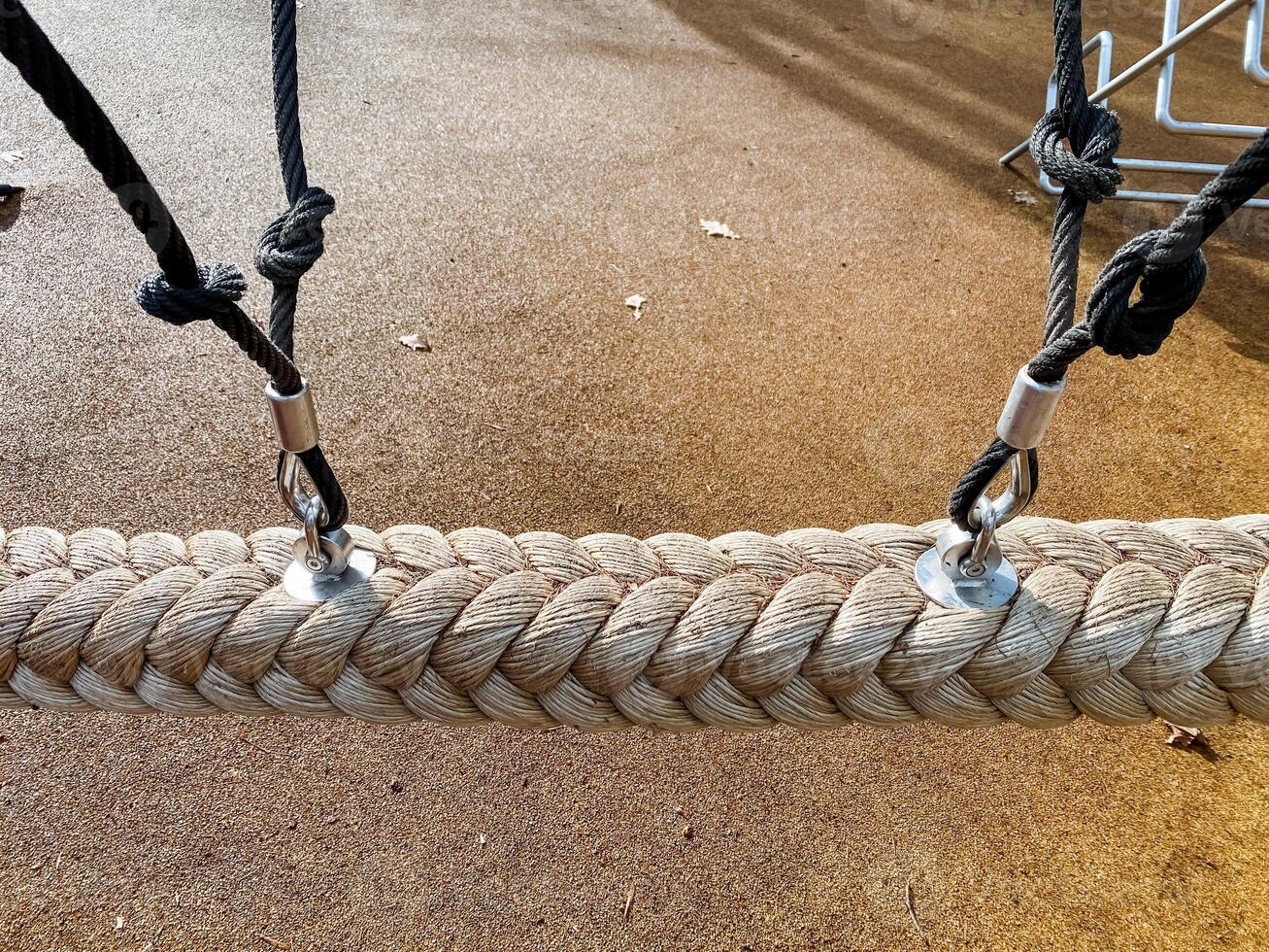 The image shows a closeup of a braided rope with metal connectors and durable black ropes in a tidy workshop, highlighting craftsmanship and versatile applications photo