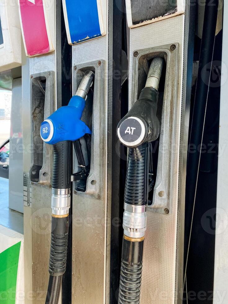 Fuel Pumps located at a Gas Station featuring ColorCoded Nozzle Handles to distinguish between Different Fuel Types for the convenience of consumers and vehicles photo