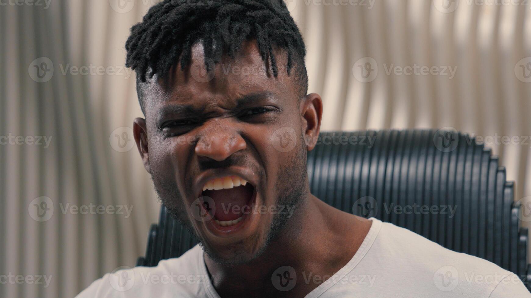 Portrait face futuristic angry mad furious authority stress screaming yelling masculine shouting screaming gamer African American man guy male in futurism modern white studio looking at camera emotion photo