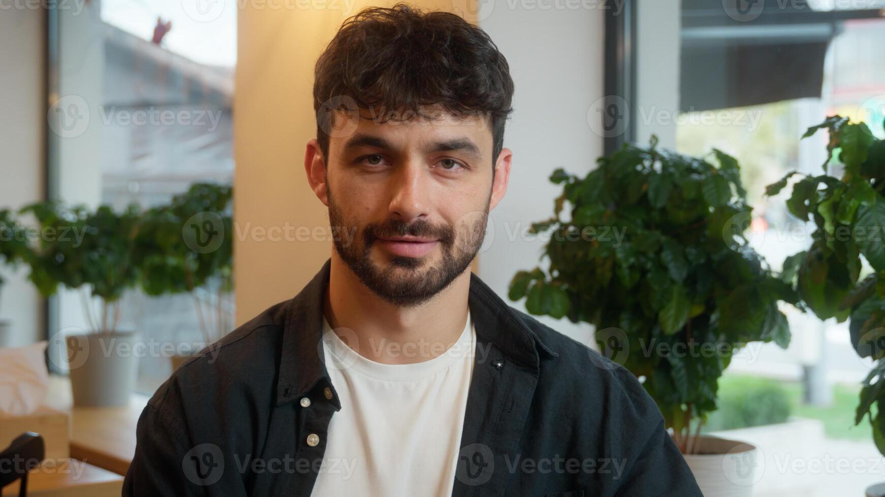 Caucasian man using mobile phone smartphone laptop working online male happy client visitor cafe restaurant employee positive smiling guy businessman business cellphone guest looking at camera indoor photo