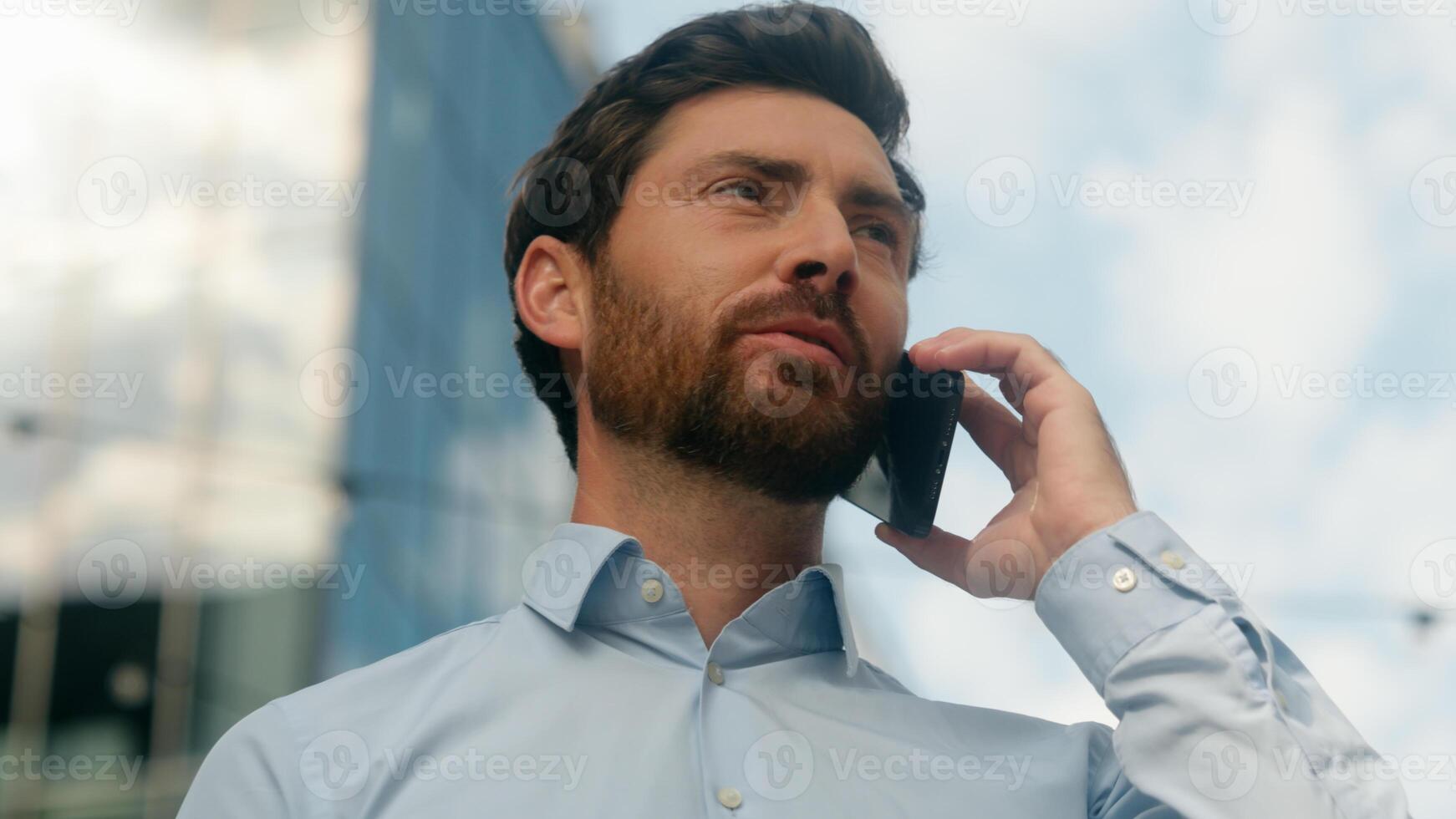 Close up Caucasian smiling happy successful middle-aged businessman business man male guy employer entrepreneur worker in sunny sun light city talking mobile phone communicate smartphone negotiate photo