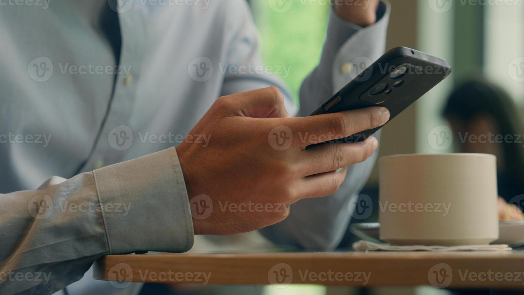 Unrecognizable business man male tourist client guest visitor in cafe restaurant Arabian ethnic guy businessman hands using mobile phone app online cellphone browsing smartphone shopping cropped view photo