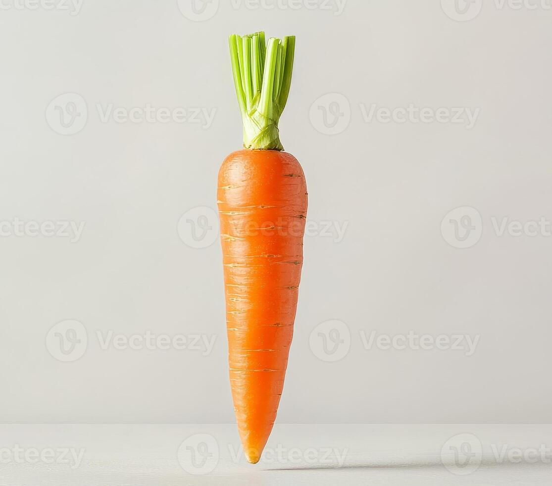 Floating carrot in mid-air concept. Fresh carrot on a simple background with green tops. photo