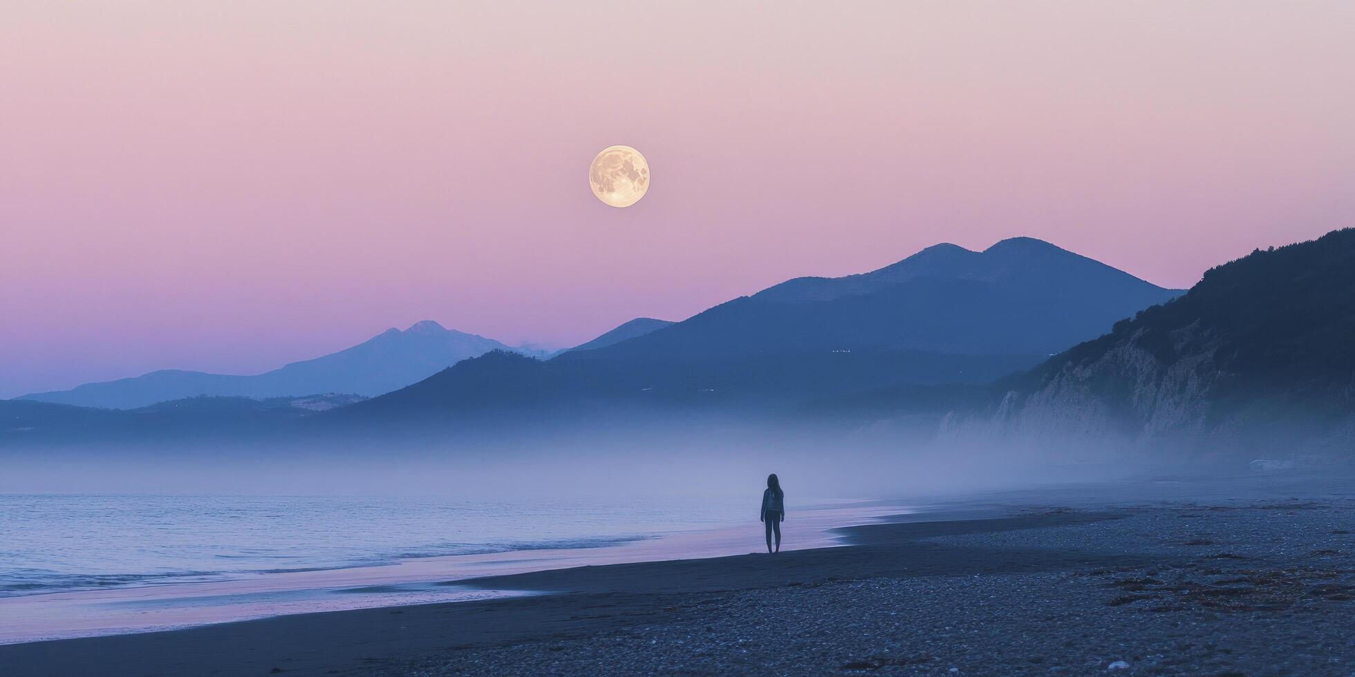 A person standing on the beach with the moon in the background photo