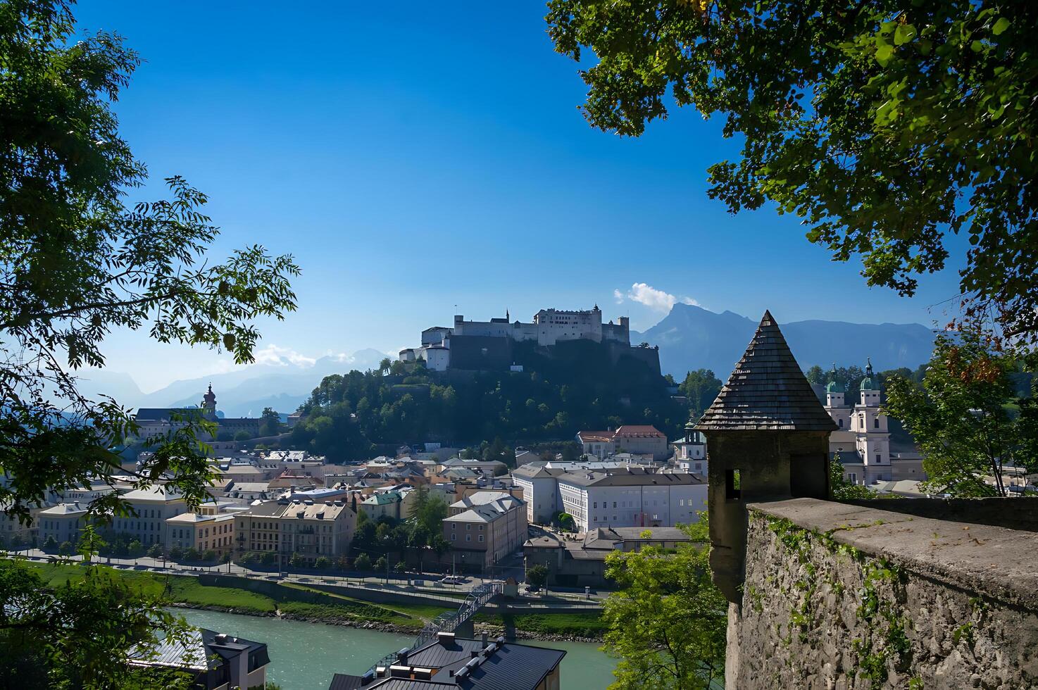 A picturesque European city sprawls along the banks of a calm river, reflecting ancient architecture in the water photo