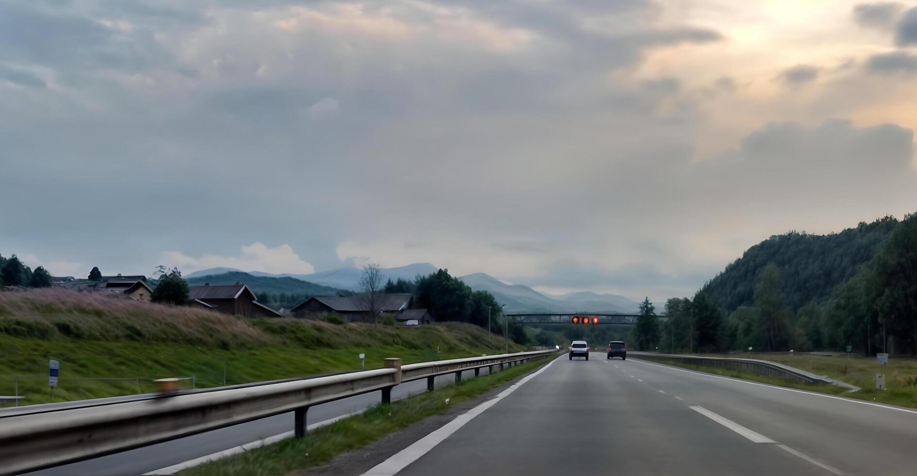 Sunset. Scenic highway winding through majestic mountains on a bright summer day. Road surrounded by green vegetation photo