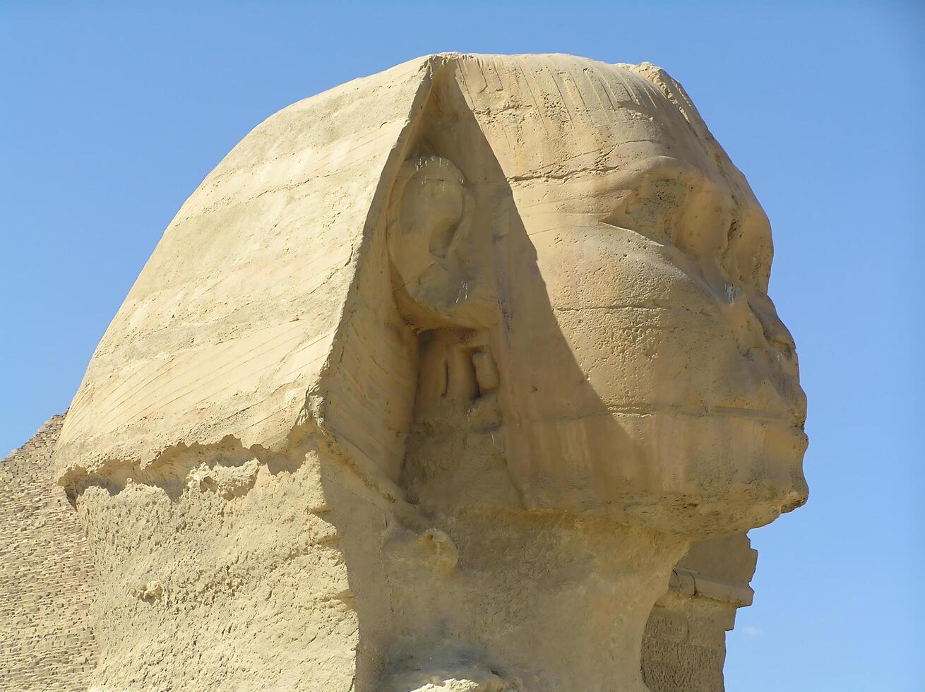 The head of the Sphinx. The legendary Great Sphinx of Giza, carved from limestone, stands majestically against the vast Egyptian desert photo