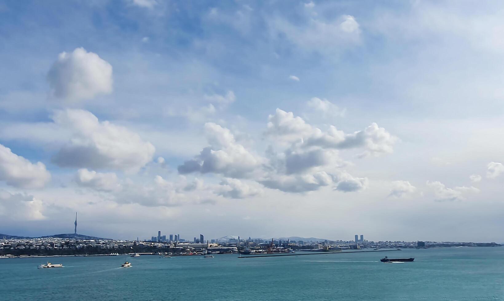 Magical sky. The picturesque city is spread out on the seashore. The sun's rays are reflected in the waves photo