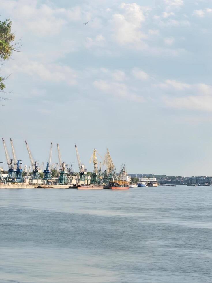 River port, large vessels and small ones stand at the pier, creating a contrast of scales photo