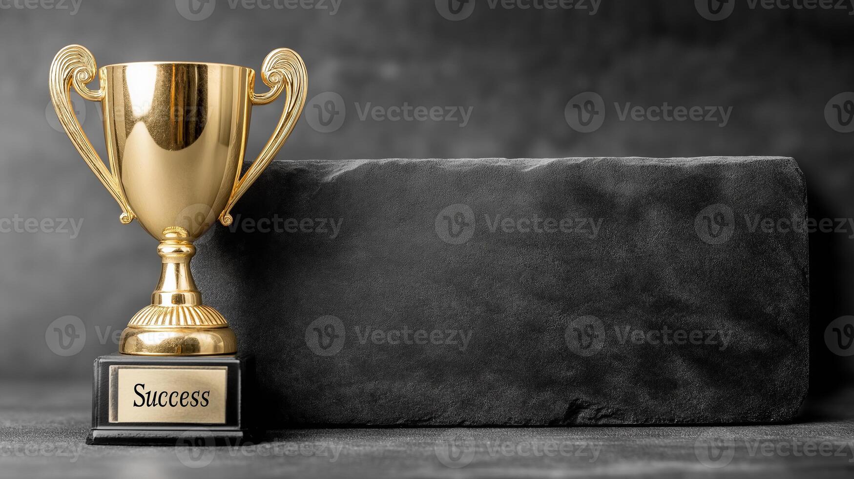 Golden trophy with Success engraved on a plaque, symbolizing achievement and victory. Positioned prominently on a dark surface, highlighting the concept of accomplishment photo