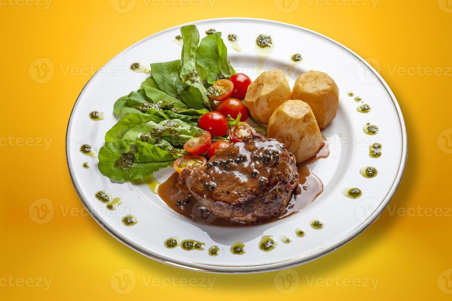 Filet mignon with sauce, salad and potato. photo