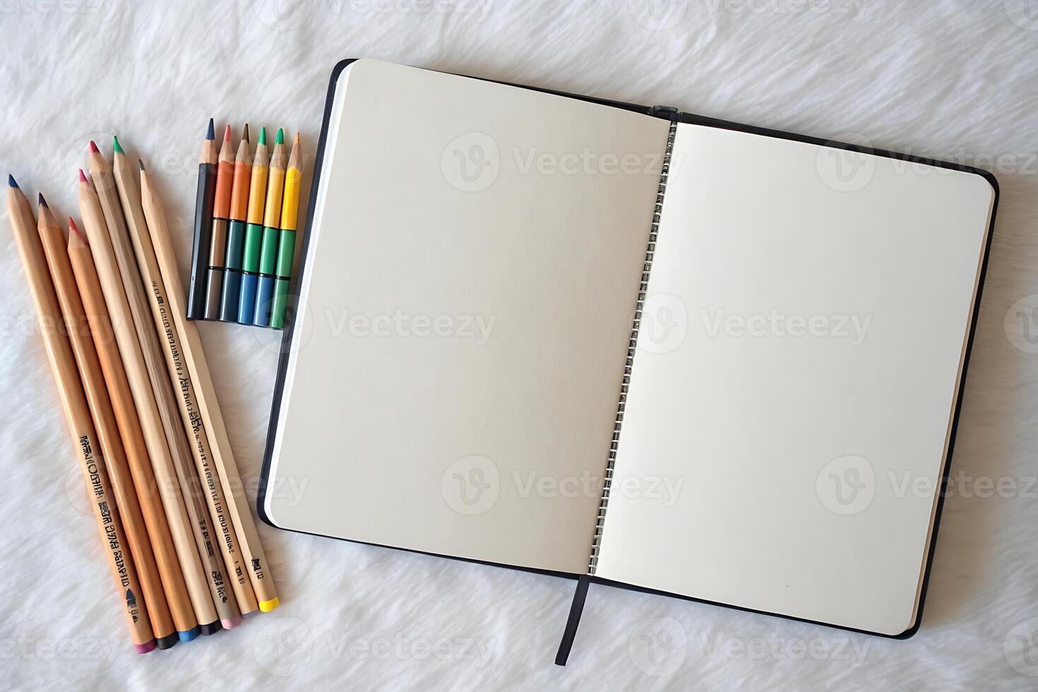 Creative beginnings month usa blank sketchbook with colorful pencils on soft fabric background photo