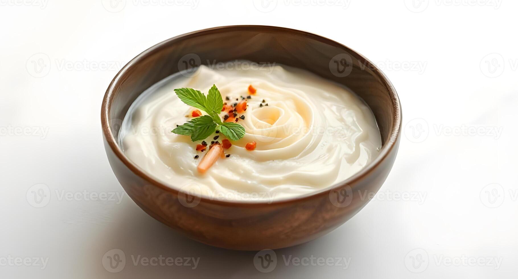 A bowl of yogurt with a garnish of herbs photo