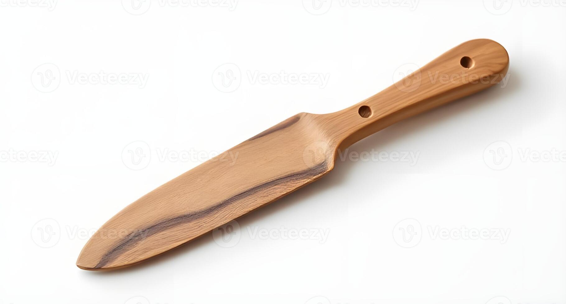 A wooden knife on a white surface photo