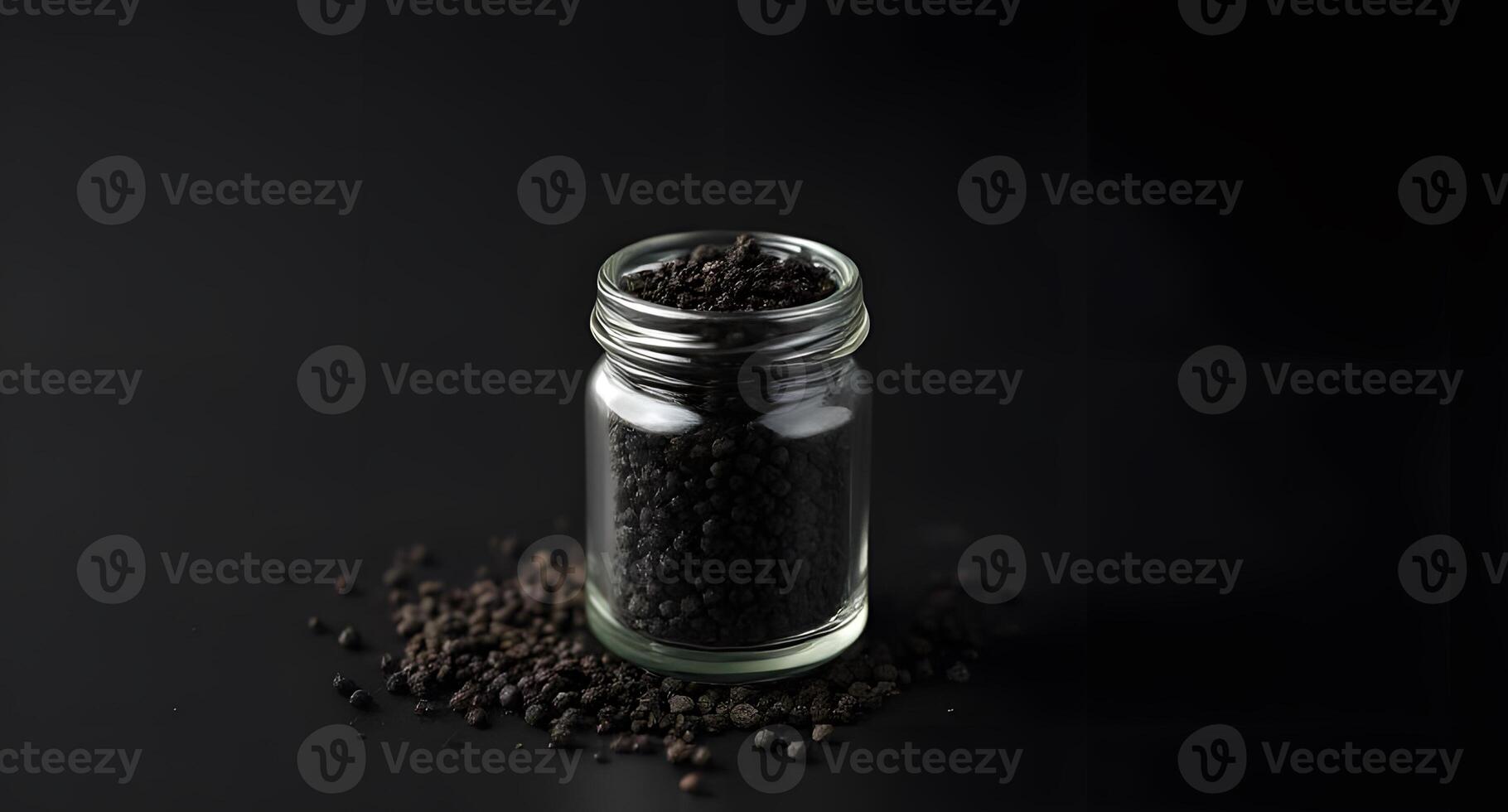 Black seed in a glass jar on a black background photo