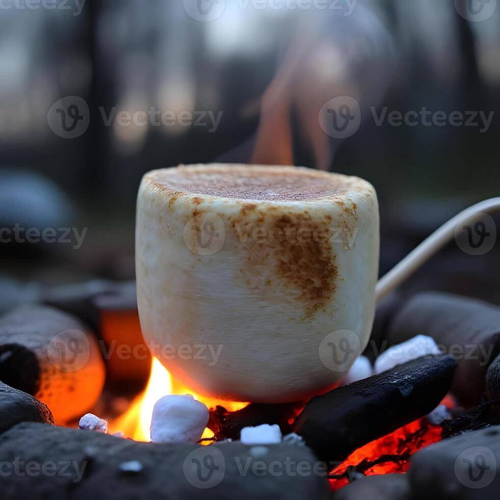 A hot chocolate cup sitting on top of a fire photo