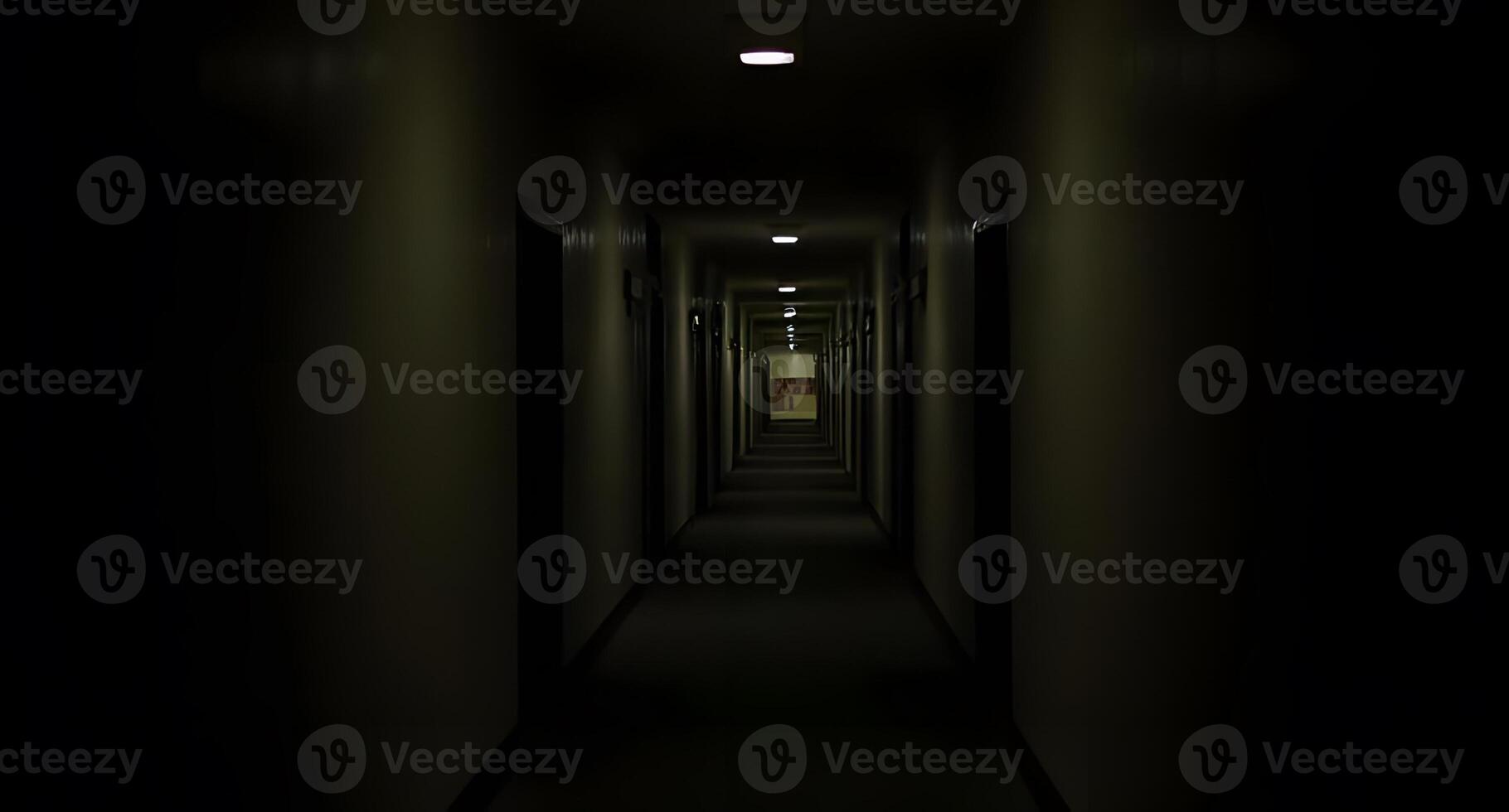 A dark hallway with a light at the end photo