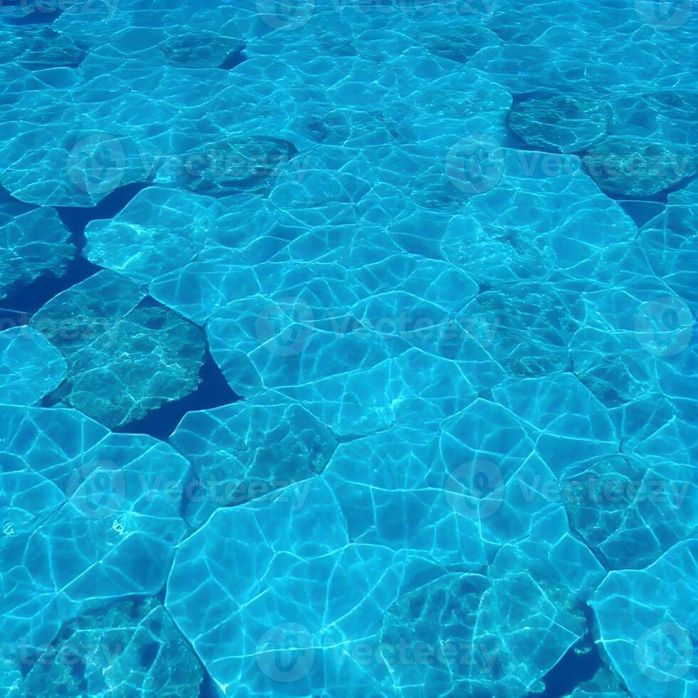 The water is clear and blue with small rocks photo