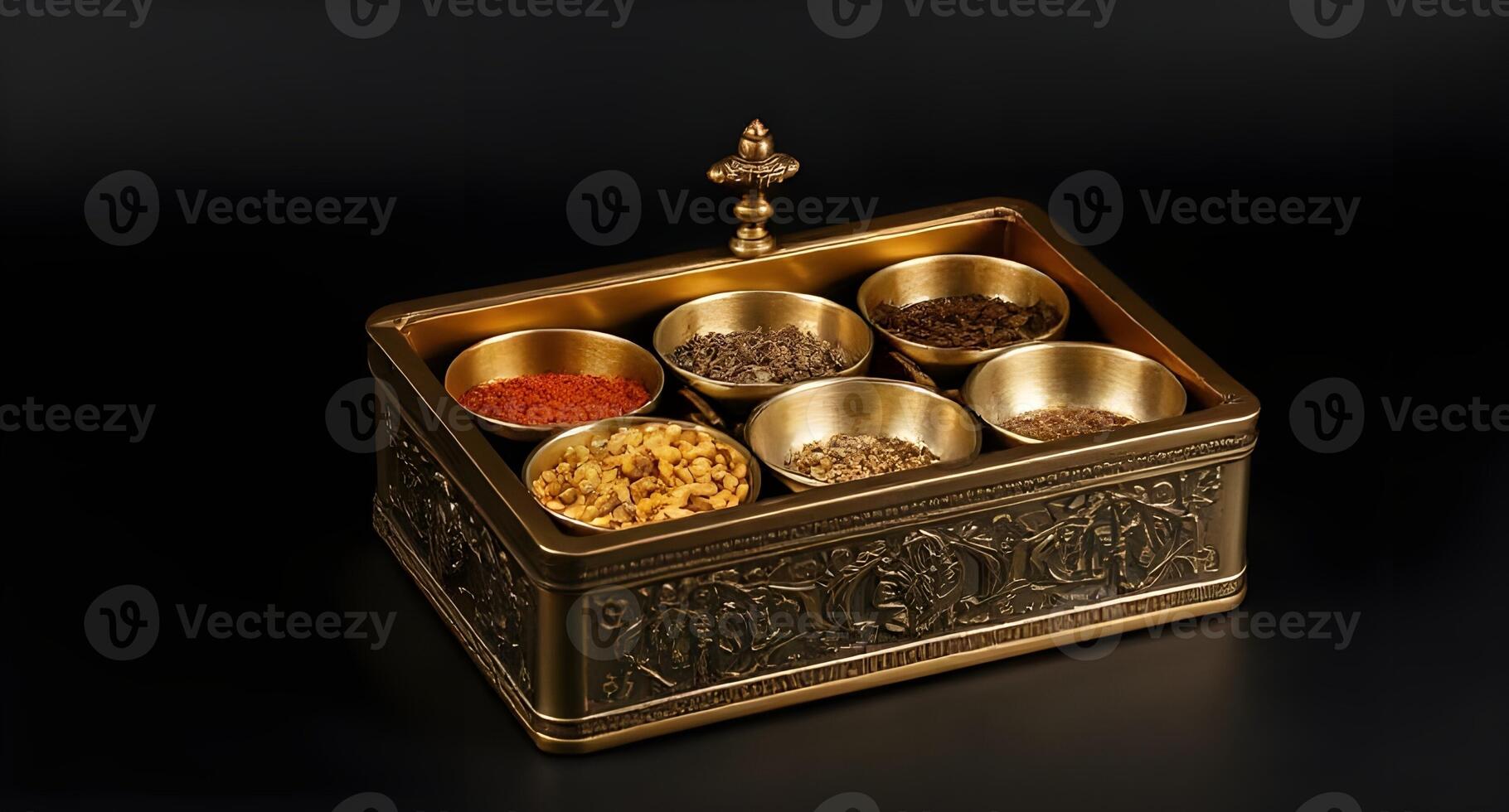 A brass box with six different spices in it photo