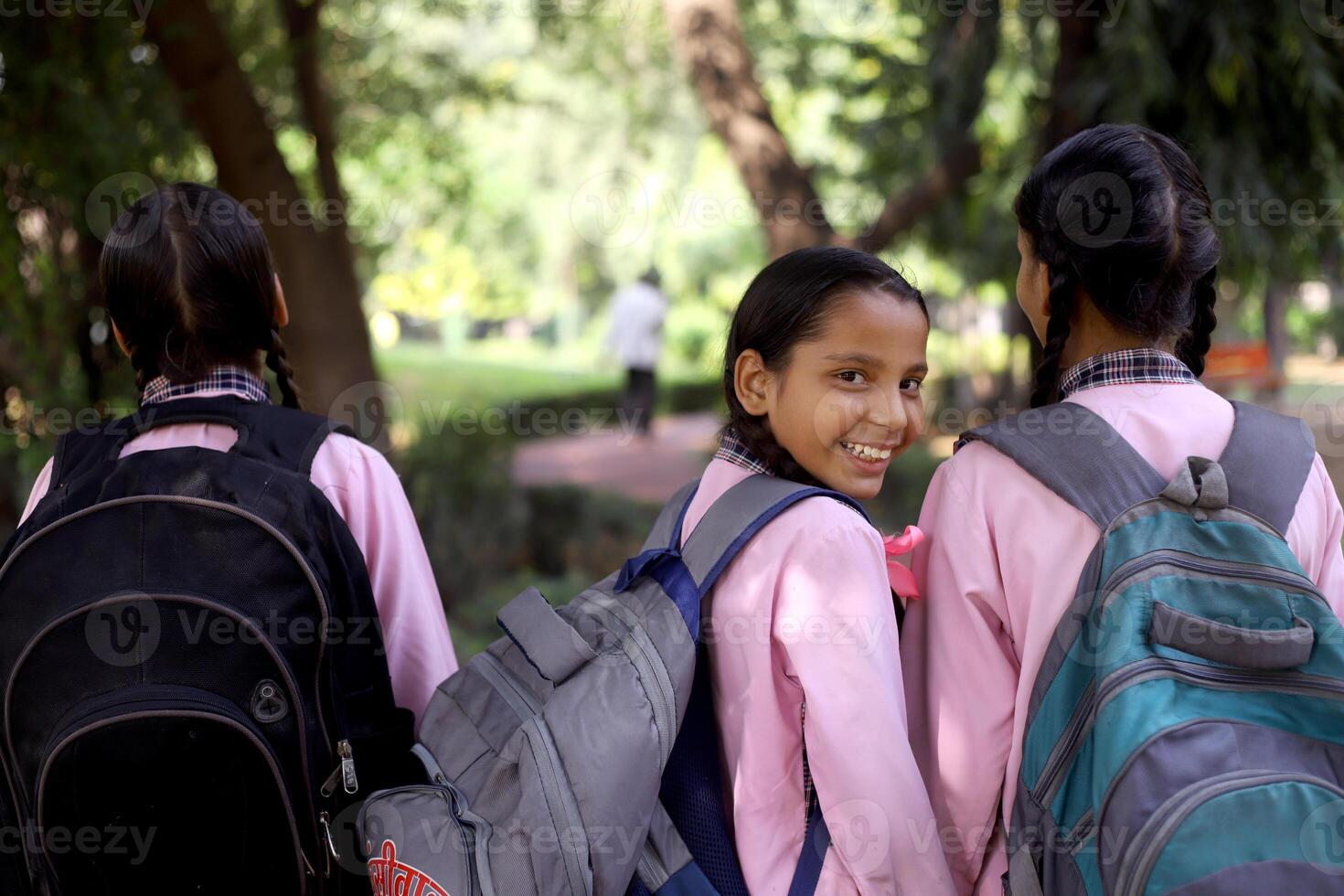 Three Village Girl Students Are Sitting In An Auto And One Of Them Is Looking Back photo