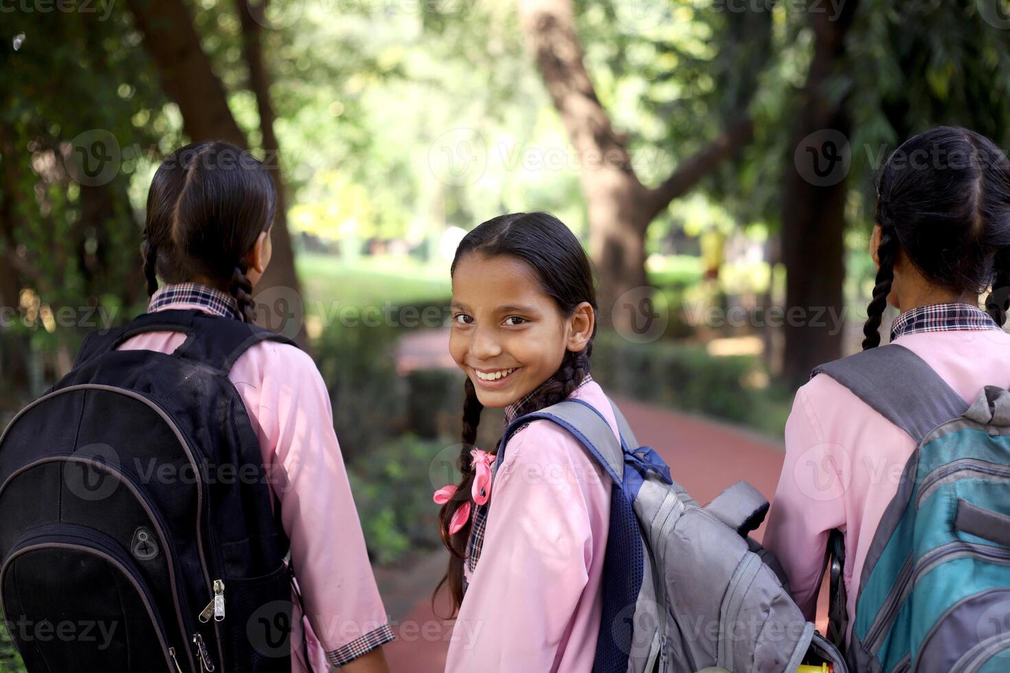 India Rural Area Girl Student Showing Black Slate With Both The Hands Raised Up photo