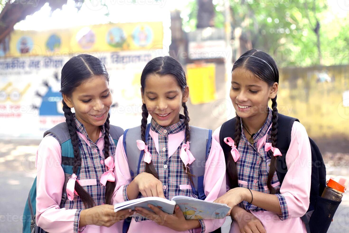 Village Kids Posing In Front Of The Camera While Holding Books photo