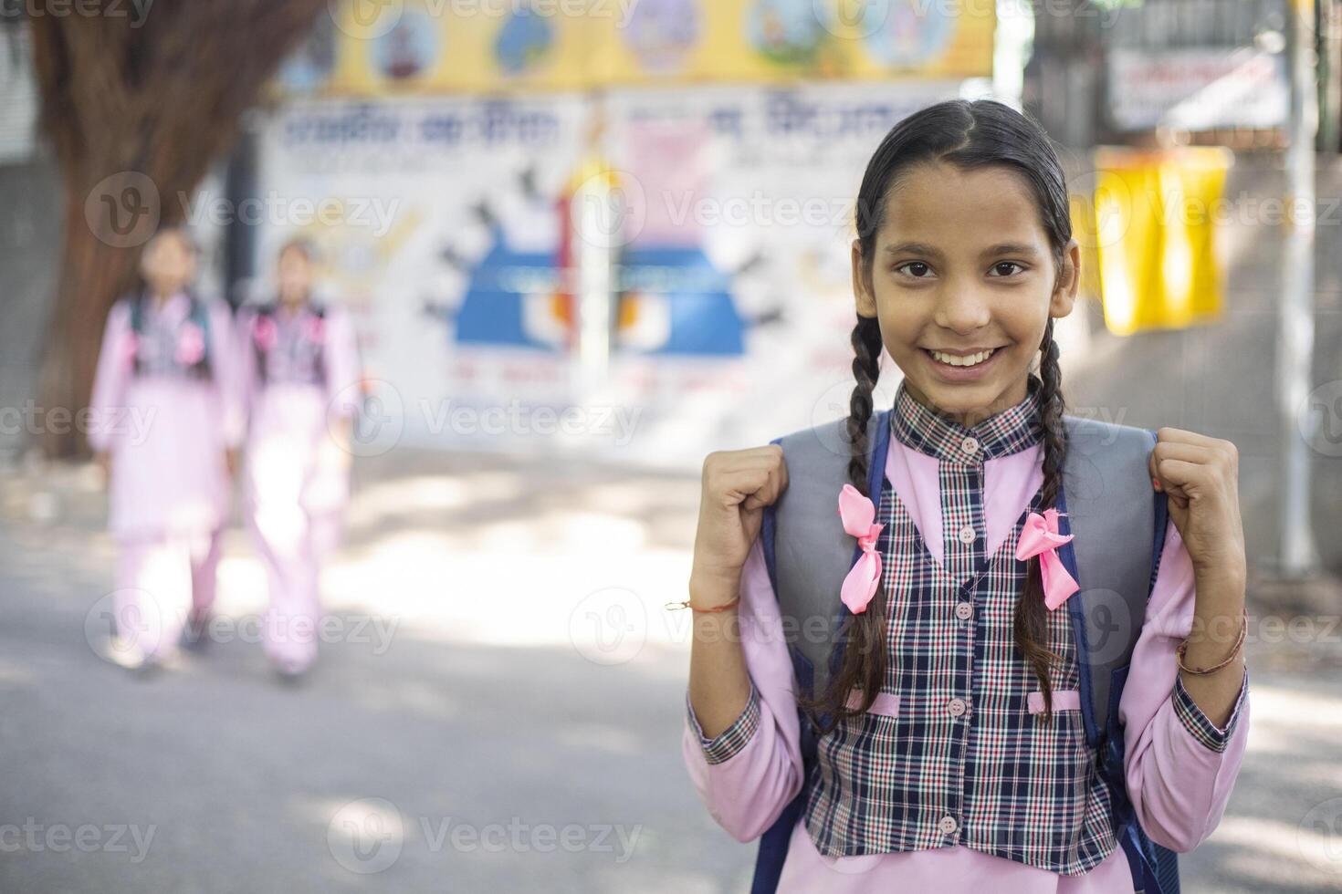 A Girl Smiling While Reading A Book photo