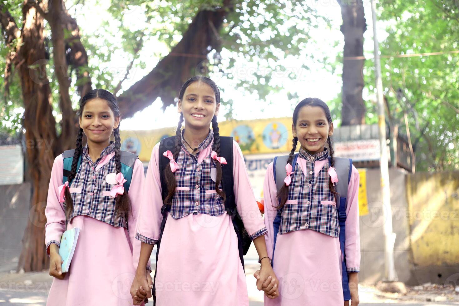 Students From Indian Girl Are Smiling As They Read The Book photo