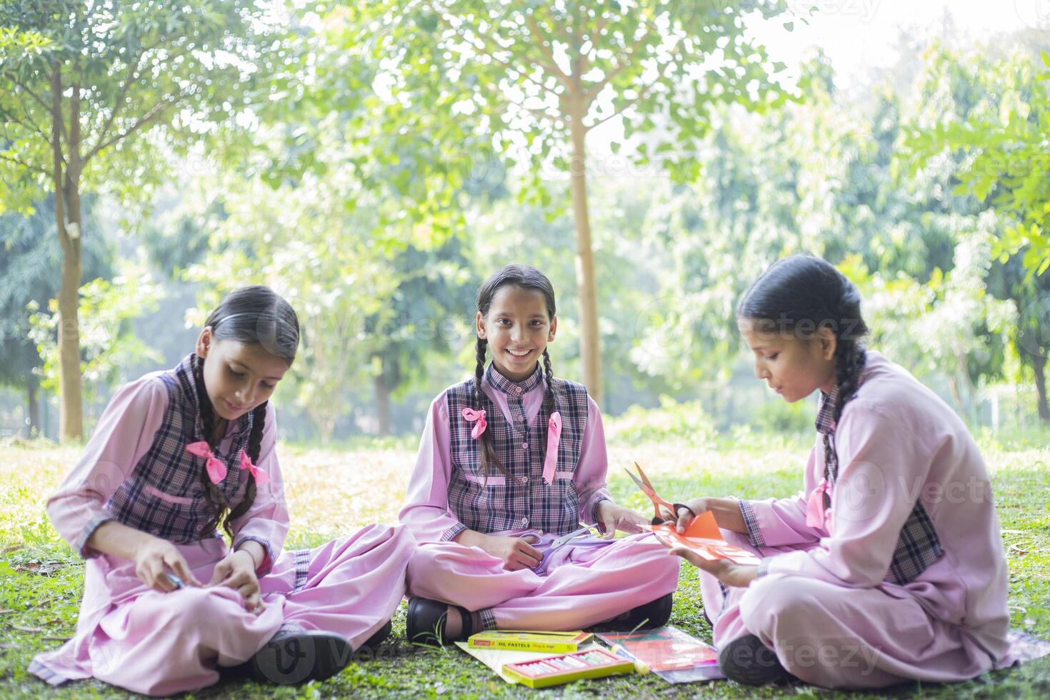 Three Adult Friends Laughing While Studying In The Park photo