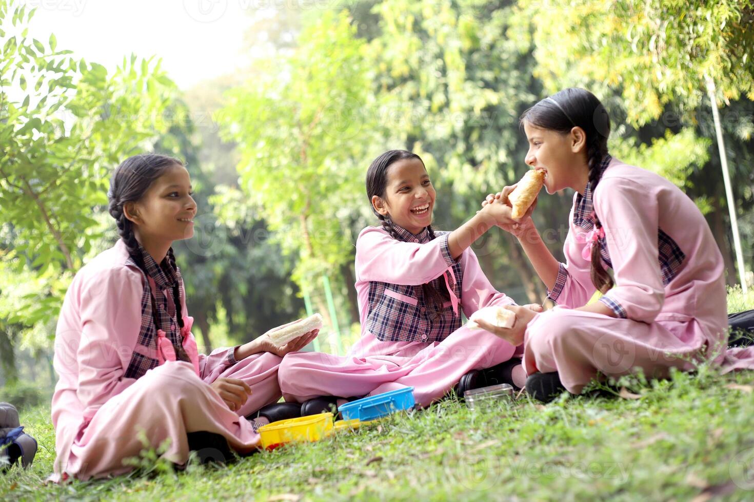3 Students Are Standing Outside The School And Holding Each Other'S Hands photo