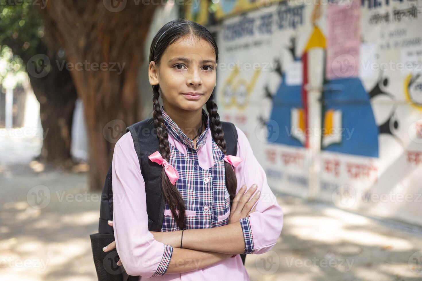 Indian Village Shy Girls In School Uniform Holding Slate In Hand While Posing In Front Of Camera photo