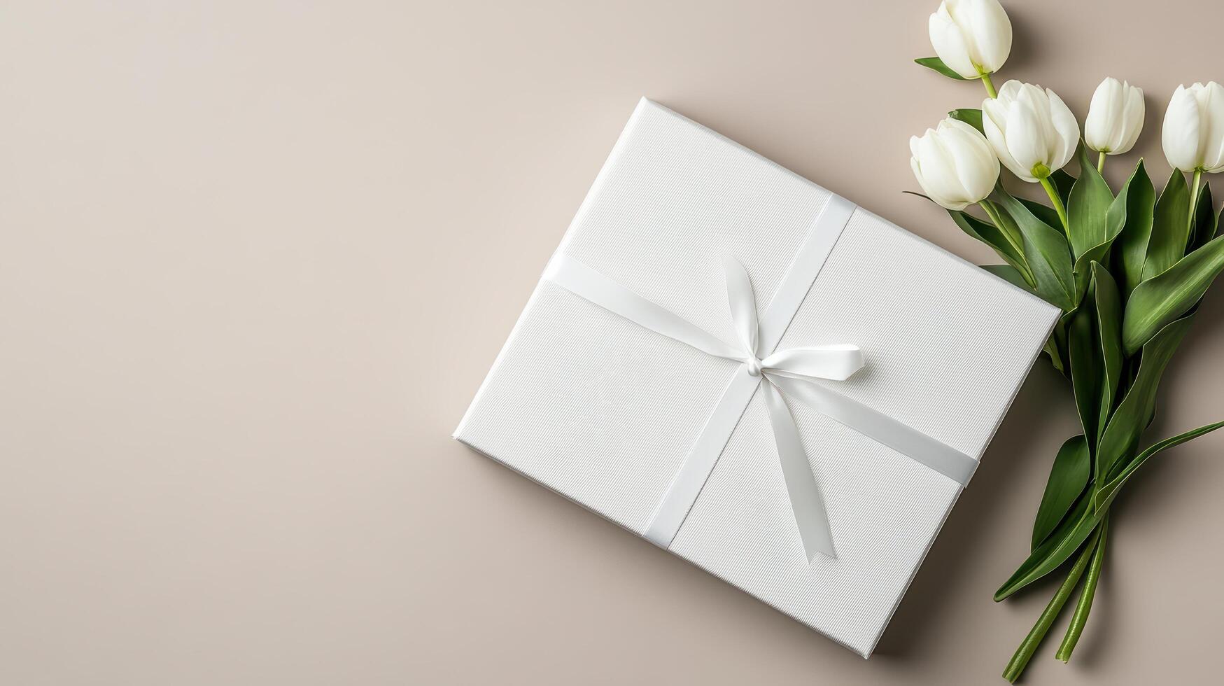 White tulips and gift box on beige background photo