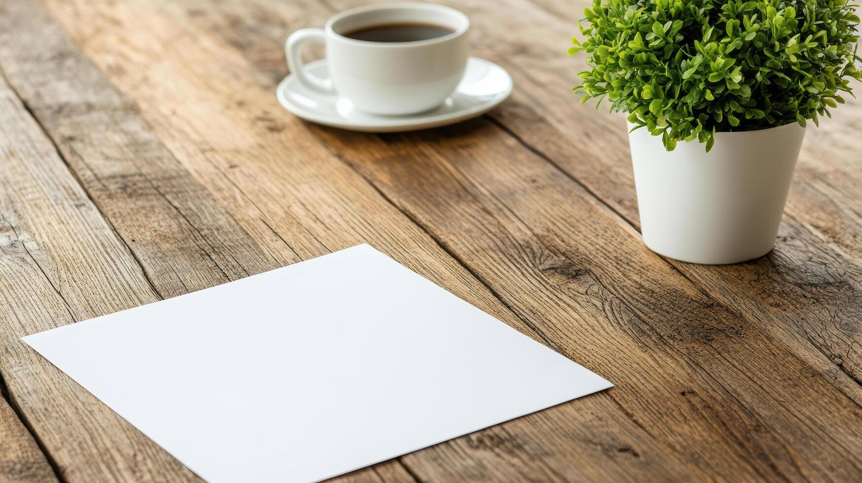 Blank paper and cup of coffee on wooden table photo