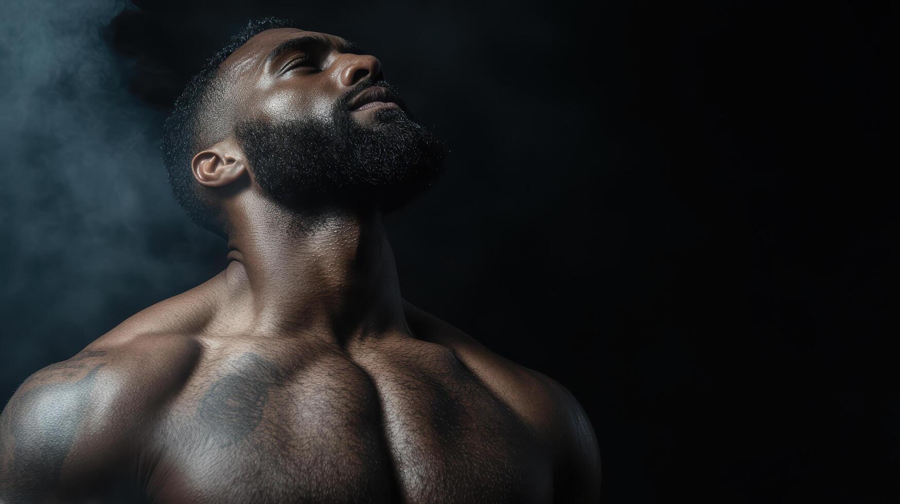 A man with a tattooed chest and chest is standing in smoke photo