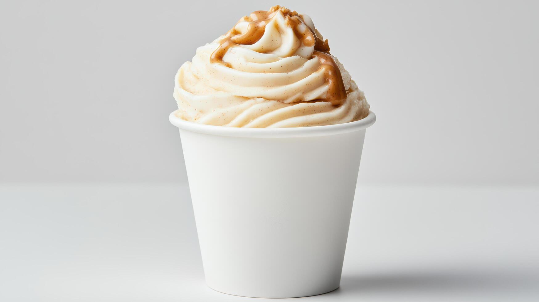 A cup of ice cream with caramel sauce on top photo
