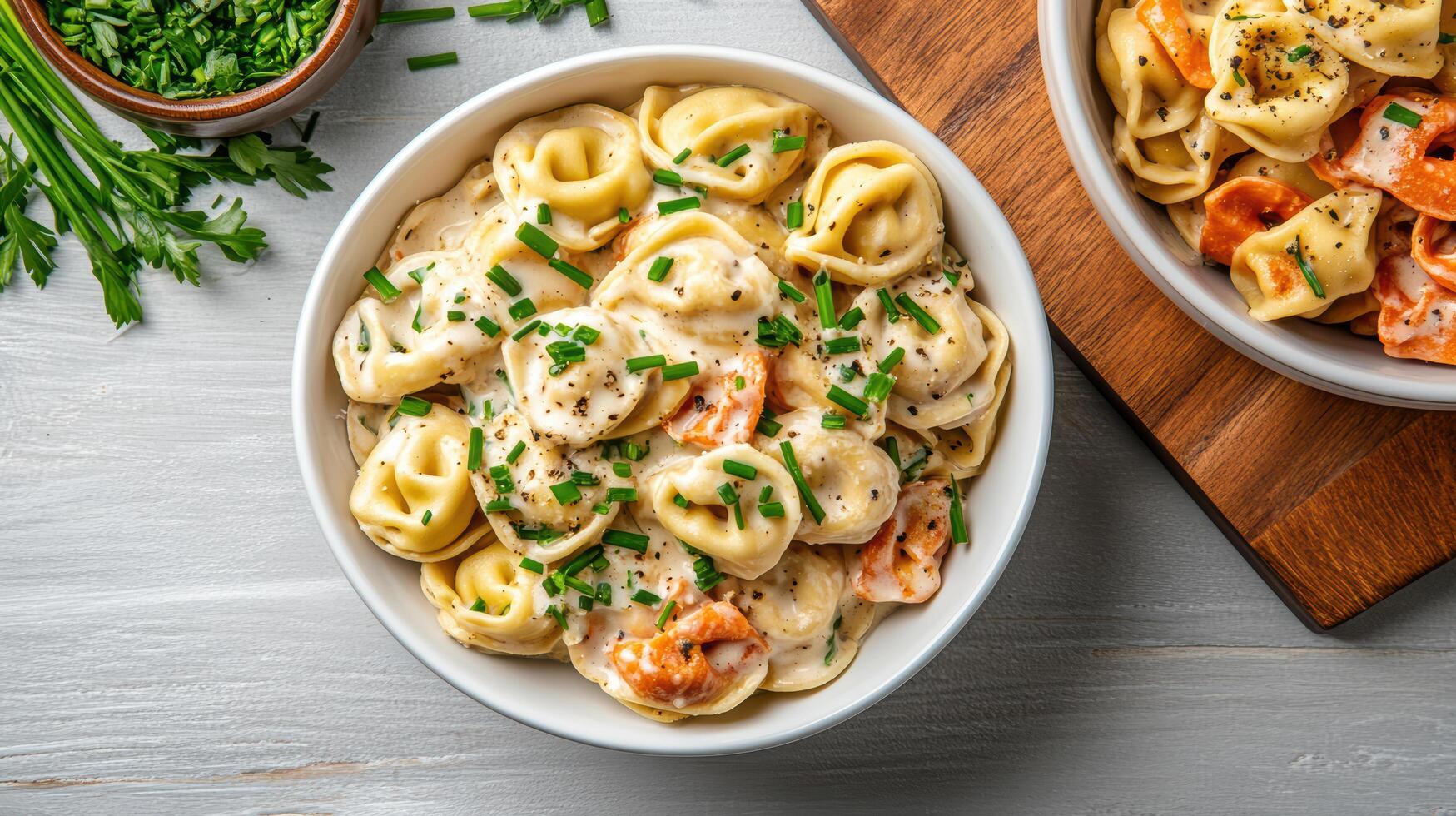Two bowls of pasta with cheese and herbs photo