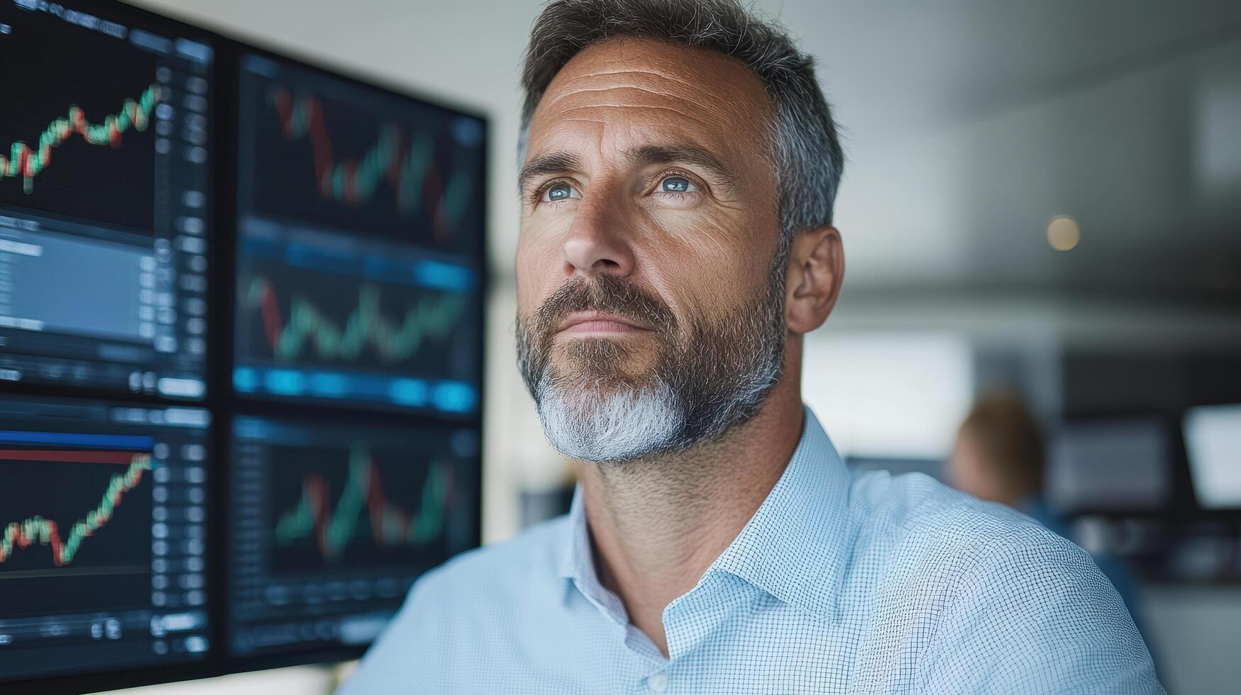 A man looking at stock market graphs photo