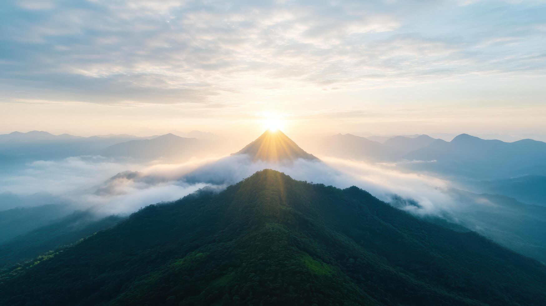 breathtaking view of mountain peak illuminated by sun, surrounded by clouds and distant hills photo