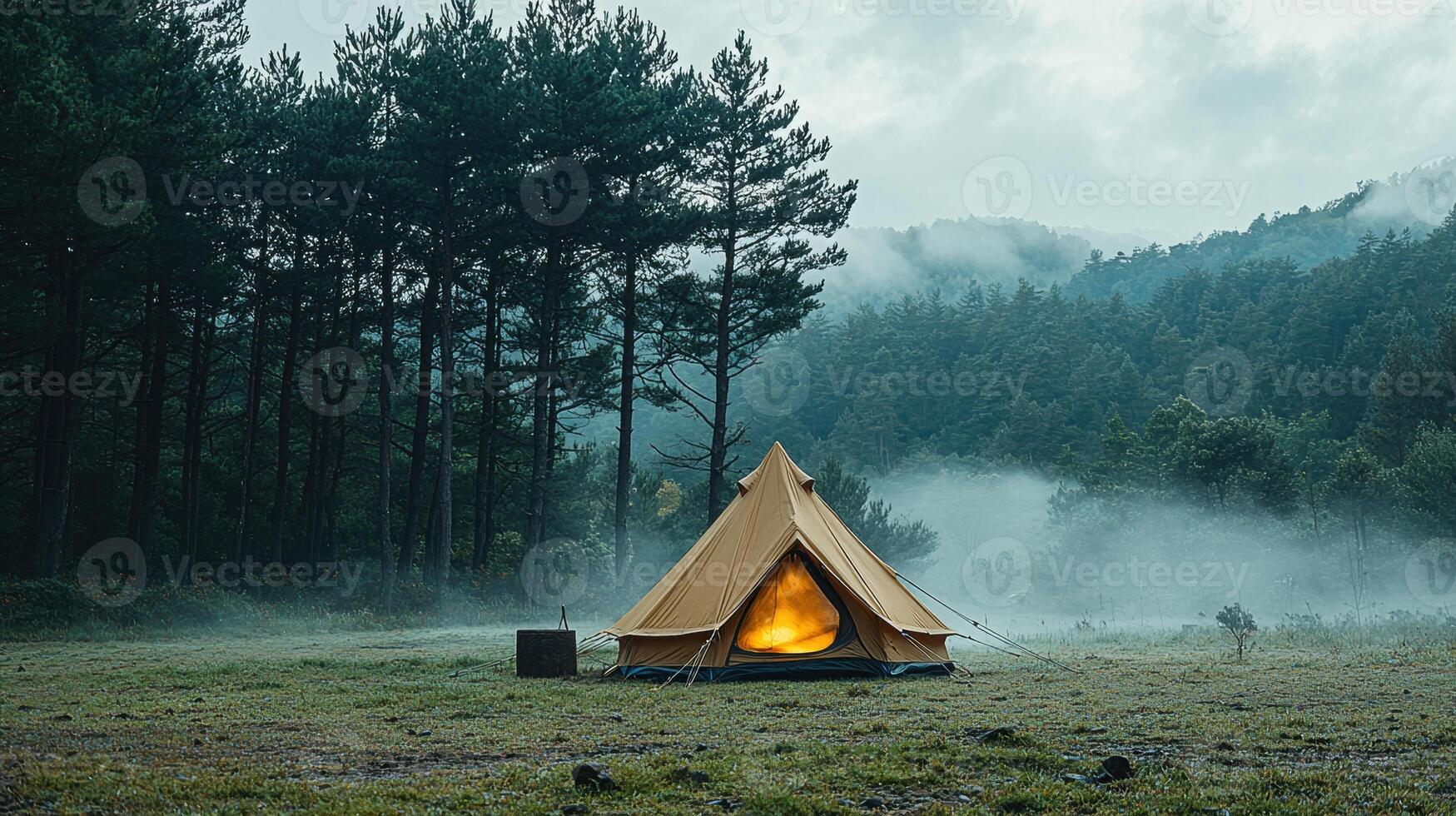 serene camping scene features cozy tent glowing warmly amidst misty forest. tall trees surround campsite, creating peaceful atmosphere perfect for outdoor adventures photo