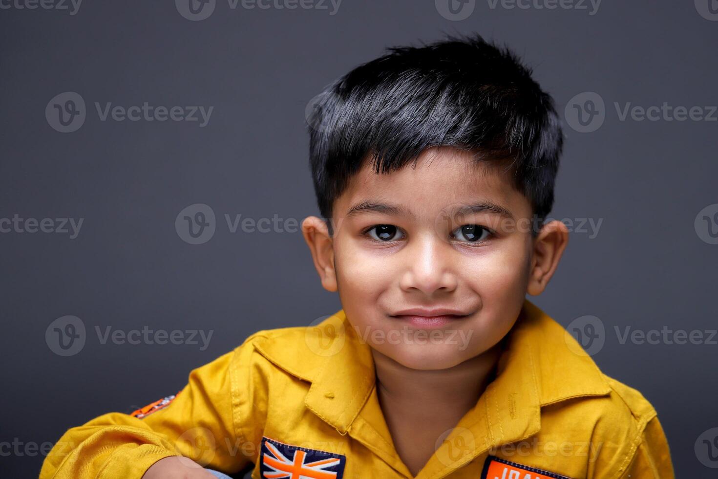 Close-Up View Of Happy Child Posing While Looking At The Camera photo