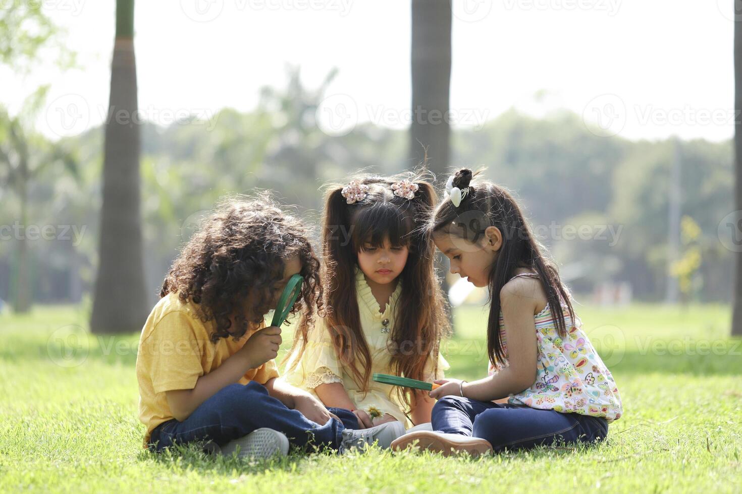 Three Little Friends Naturalist Scientists Exploresa White Flower photo