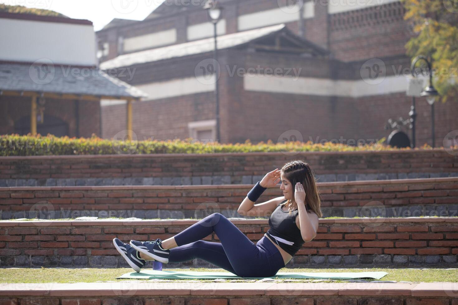 Fit Woman Doing Elbow To Knee Crunches Workout In Park photo