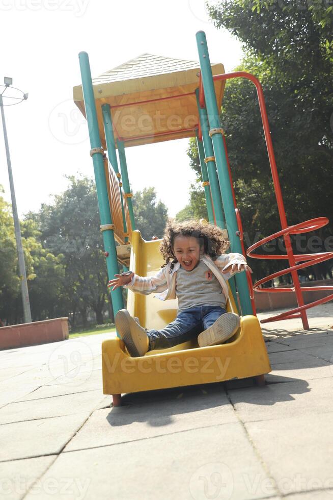 Naughty Boy Playing Slider At Playground photo