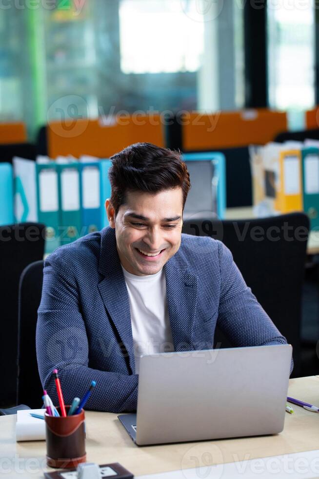 Professional Man Looking At Laptop With Positive Smile Reading Email photo