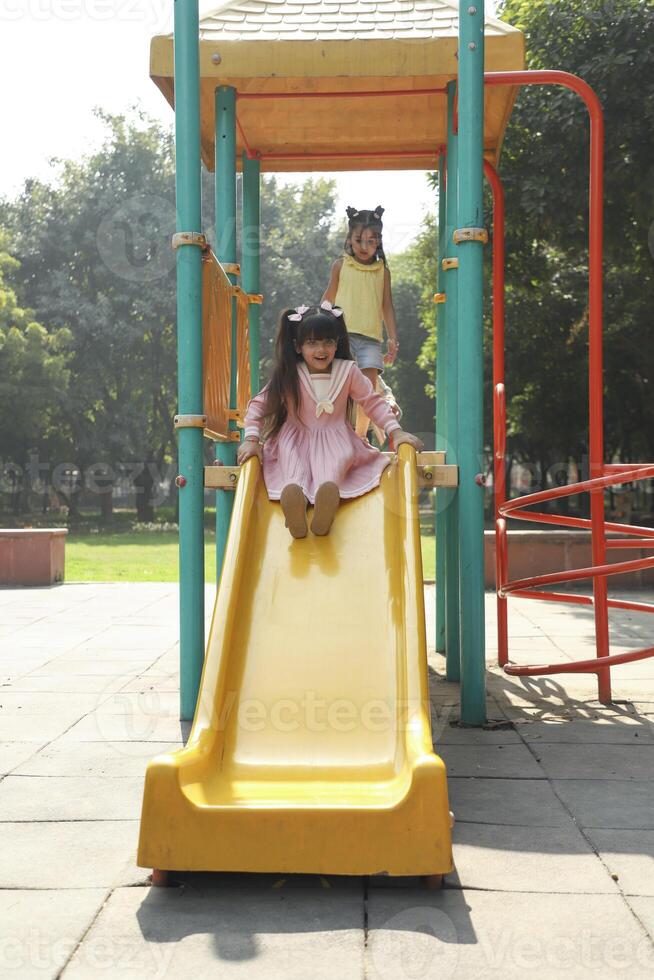 Prep Kids Having Fun Time Enjoying On Slide photo