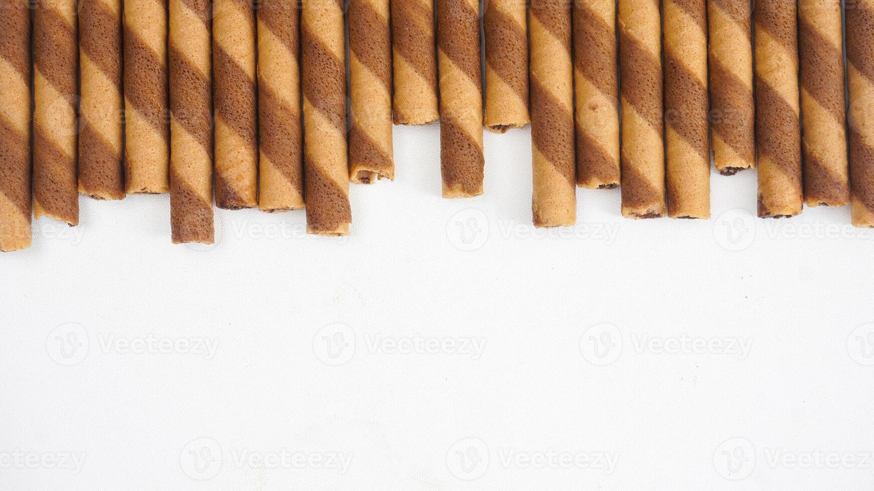 Crunchy wafer rolls with a chocolate swirl isolated on white background photo