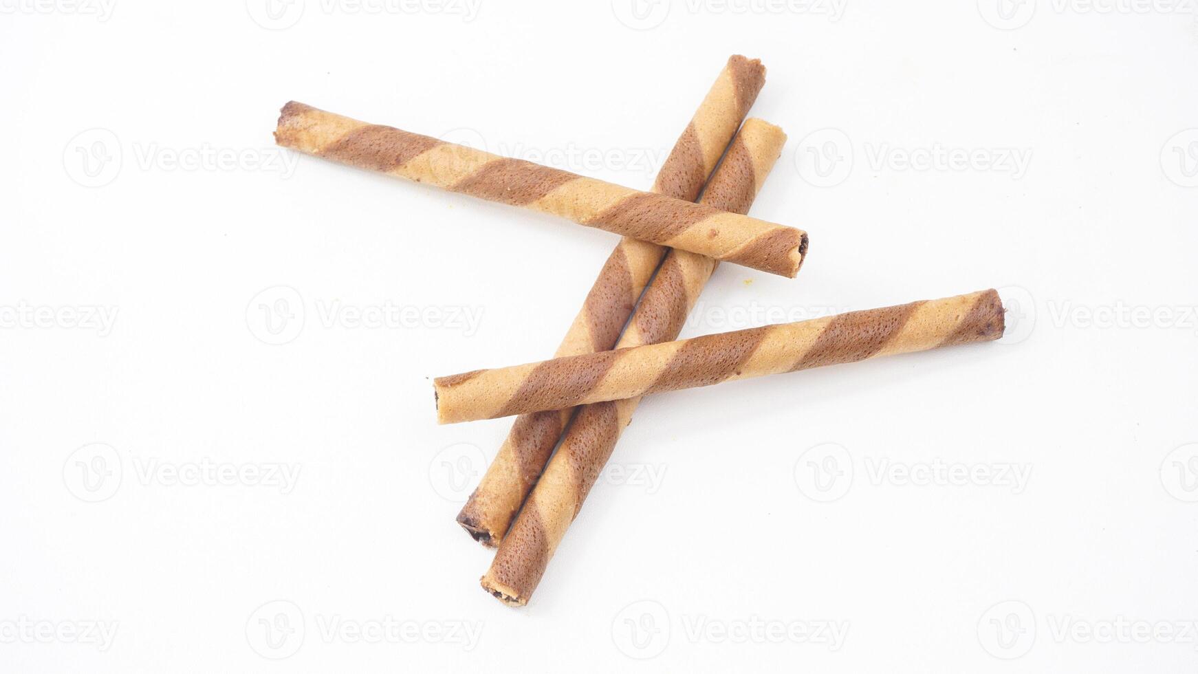 Chocolate wafer rolls stacked neatly isolated on white background photo