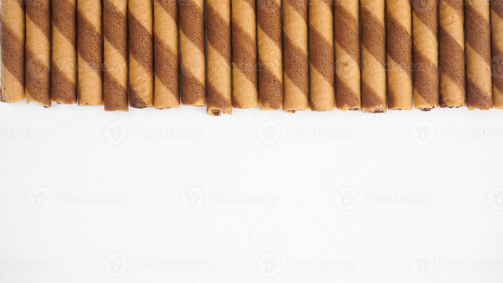 Chocolate wafer rolls arranged neatly isolated on white background photo