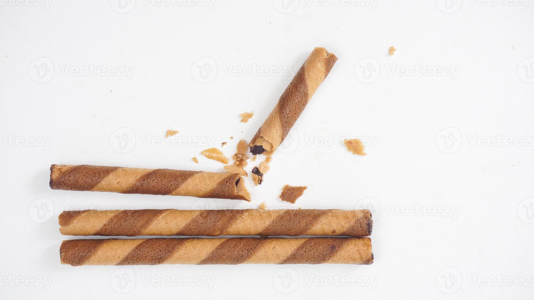 Light and airy chocolate wafer rolls isolated on white background photo